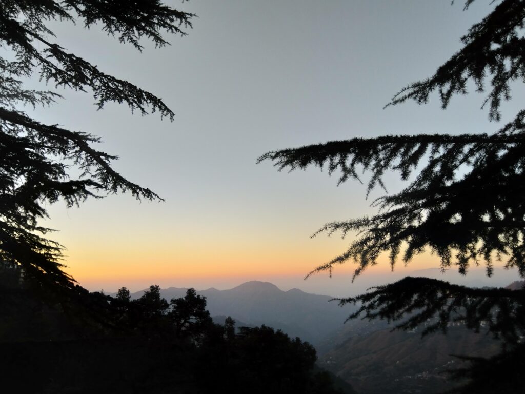 Mist covered mountains in the golden hour in Shimla, a town in Himachal Himalayas