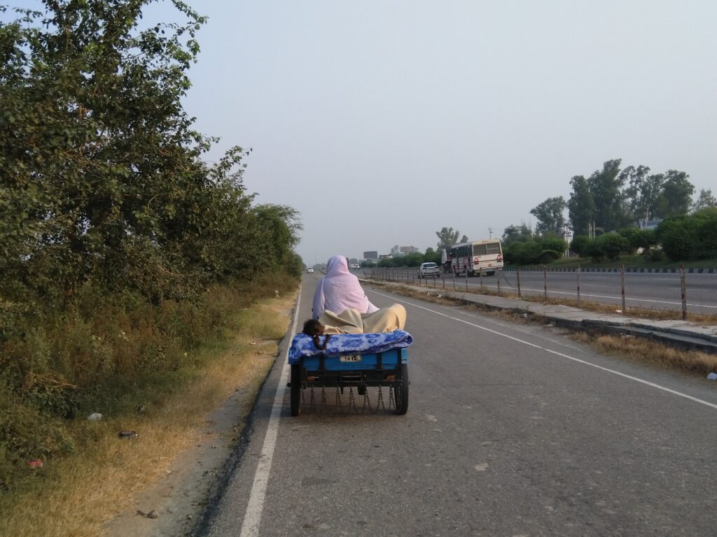 A father driving his sleeping daughter in a simple van in early morning