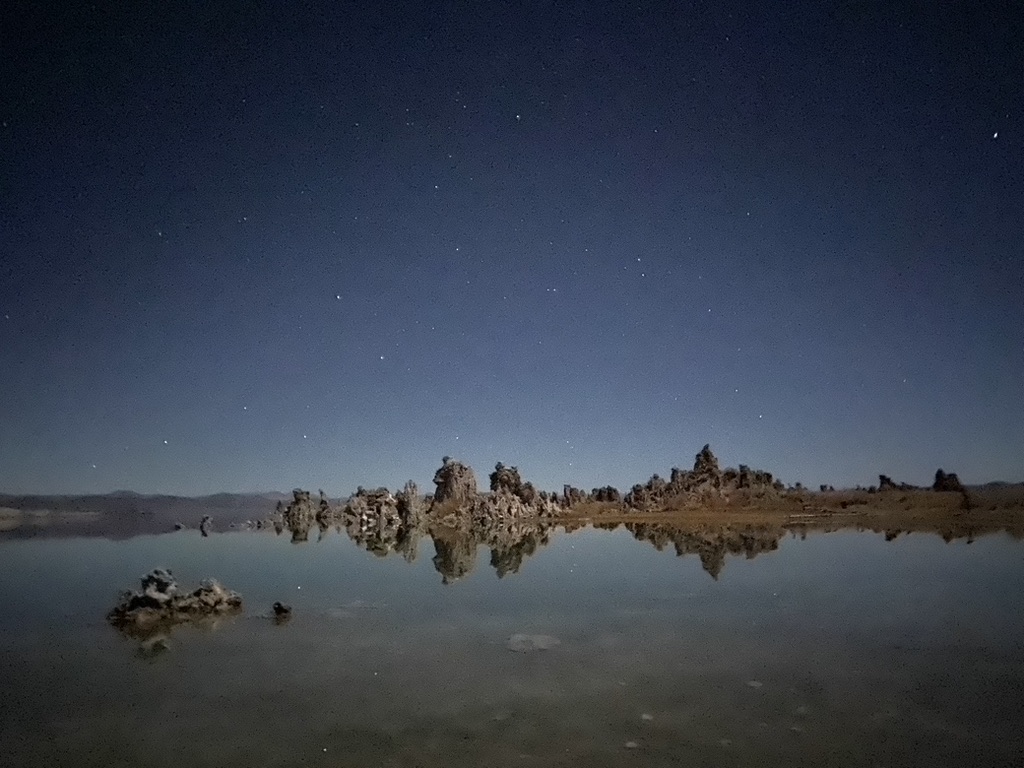 Moonlit Tufas at Mono Lake under a clear starry winter sky, a vista from the road trip through California